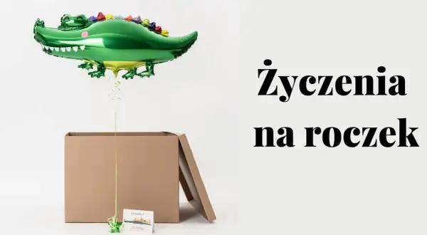 Zielony balon w kształcie krokodyla unosi się nad otwartym kartonem. Obok tekst: "Życzenia na roczek".